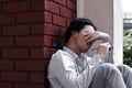 Tired overworked young Asian business man close his eyes and covering face Royalty Free Stock Photo