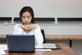 Tired overworked young Asian business woman close her eyes closed in workplace. Royalty Free Stock Photo