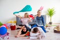 Tired parents and romping kids Royalty Free Stock Photo