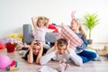 Tired parents and romping kids Royalty Free Stock Photo