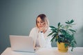 Tired pensive Caucasian business woman working on laptop computer. Freelancer working remotely on Internet from home office.