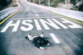 Tired powerless man in black jacket and grey trousers fallen on road overcome deadline title written on asphalt