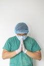 Tired praying doctor at the hospital. A doctor, a nurse who is thinking about treating a disease and a pandemic. Surgeon after Royalty Free Stock Photo