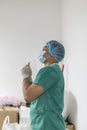 Tired praying doctor at the hospital. A doctor, a nurse who is thinking about treating a disease and a pandemic. Surgeon after Royalty Free Stock Photo