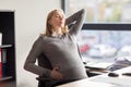 Tired pregnant businesswoman at office work Royalty Free Stock Photo