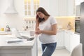 Tired pregnant woman working in kitchen at home. Maternity leave Royalty Free Stock Photo