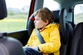 Tired preschool kid boy sitting in car during traffic jam Royalty Free Stock Photo