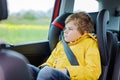 Tired preschool kid boy sitting in car during traffic jam Royalty Free Stock Photo