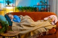 Tired teen child girl kid lying down in bed taking a rest at home, napping, falling asleep on sofa Royalty Free Stock Photo