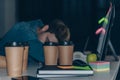 tired programmer sleeping at workplace at night in office. Royalty Free Stock Photo