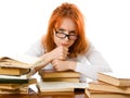 Tired red-haired girl in glasses with books