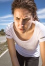 Tired runner girl sweating after running with sun