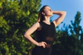 Tired runner sweating after running hard in countryside road. Exhausted sweaty woman after marathon training on hot Royalty Free Stock Photo