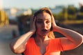 Tired runner sweating after running hard in countryside road. Exhausted sweaty woman after marathon training on hot Royalty Free Stock Photo