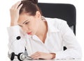 Tired, sad business woman at call center. Royalty Free Stock Photo