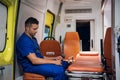 Tired and sad corpsman sits inside the ambulance car