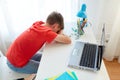Tired or sad student boy with laptop at home Royalty Free Stock Photo