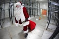 Tired Santa Claus loosing gifts from red sack