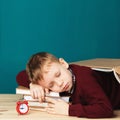 Tired school boy asleep on books. little student sleeping on tex Royalty Free Stock Photo