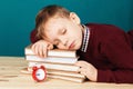 Tired school boy asleep on books. little student sleeping on tex Royalty Free Stock Photo