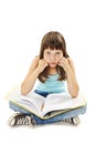 Tired school girl, frustrated and overwhelmed by studying homework. Young girl sitting down on floor