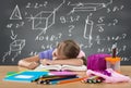 Tired school girl sleeping on the bench, behind heavy duties on the board Royalty Free Stock Photo