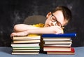 Boy sleepeing on top of books Royalty Free Stock Photo