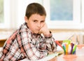 Tired schoolboy in classroom