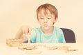 Tired schoolboy over white background. Sad or bored boy with hard difficult task. Wooden structure problems. Early education and Royalty Free Stock Photo