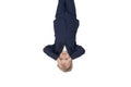 Tired schoolboy put hands on forehead. Portrait of boy in school uniform upside down. Isolated on white background