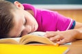 Tired schoolboy sleeping on book Royalty Free Stock Photo