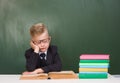 Tired schoolboy sleeps in classroom Royalty Free Stock Photo