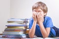 Tired schoolboy with stack of books. Close up Royalty Free Stock Photo