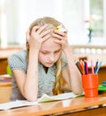 Tired schoolgirl in classroom