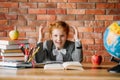 Tired schoolgirl doing homework at the table Royalty Free Stock Photo