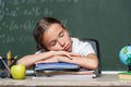 tired schoolgirl sleeping on notebooks near Royalty Free Stock Photo