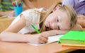 Tired schoolgirl spoils the eyesight during the exam