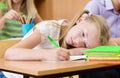 Tired schoolgirl spoils the eyesight during the exam Royalty Free Stock Photo