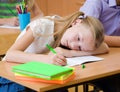 Tired schoolgirl spoils the eyesight during the exam Royalty Free Stock Photo