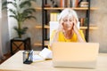 Tired senior business woman is using laptop Royalty Free Stock Photo