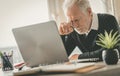 Tired senior businessman sitting in office Royalty Free Stock Photo