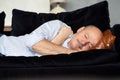 Tired senior hispanic man sleeping on couch, taking afternoon nap