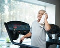 Tired senior man on a treadmill Royalty Free Stock Photo