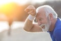 Tired senior man wiping sweat from his forehead Royalty Free Stock Photo