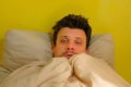 Sick man waking up with headache, sars, cold, coronavirus, portrait closeup.