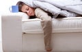Tired or sick young woman fast asleep on a sofa at home Royalty Free Stock Photo