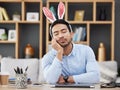 Tired, sleeping and a man for easter in an office with bunny ears for celebration or bored of a party. Stress, rabbit