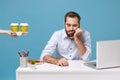 Tired sleeping man work at desk with pc laptop isolated on blue background. Food products delivery courier service from