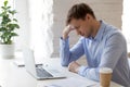 Tired sleepy businessman sitting with closed eyes at workplace