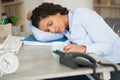 tired sleepy businesswoman resting on desk